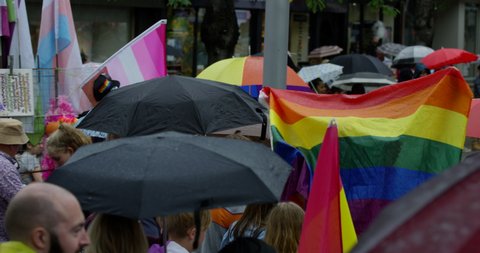 Walking And Celebrating Pride In The Rain In Colourful Nottingham People Walk Through The Streets With Rainbow Umbrellas