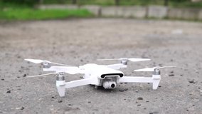 The white drone takes off on the street, close-up. 