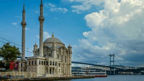 Istanbul landscape. Istanbul's populer touristic destination Ortakoy Mosque and Bosphorus Bridge view. Cloudy sky in summer day. Time lapse video