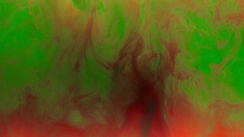Colorful yellow ink drops from above mixing in water, swirling softly underwater with red and green inks on background. Colored acrylic cloud of paint isolated. Abstract smoke explosion animation. 4K