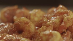 Closeup of juicy fried shrimp on fire. Slow motion video