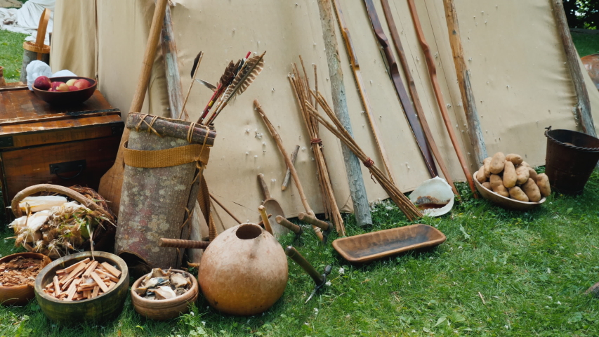 Indians household items near traditional housing - wigwam