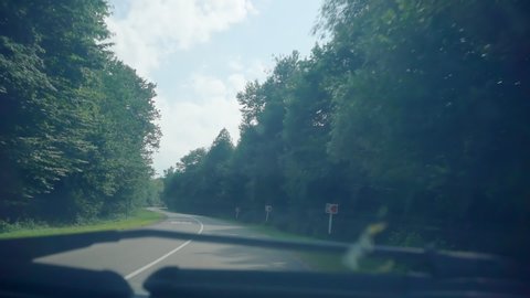 travel by car. car ride on a mountain winding road on a summer day. view through the glass from a car. first person view.