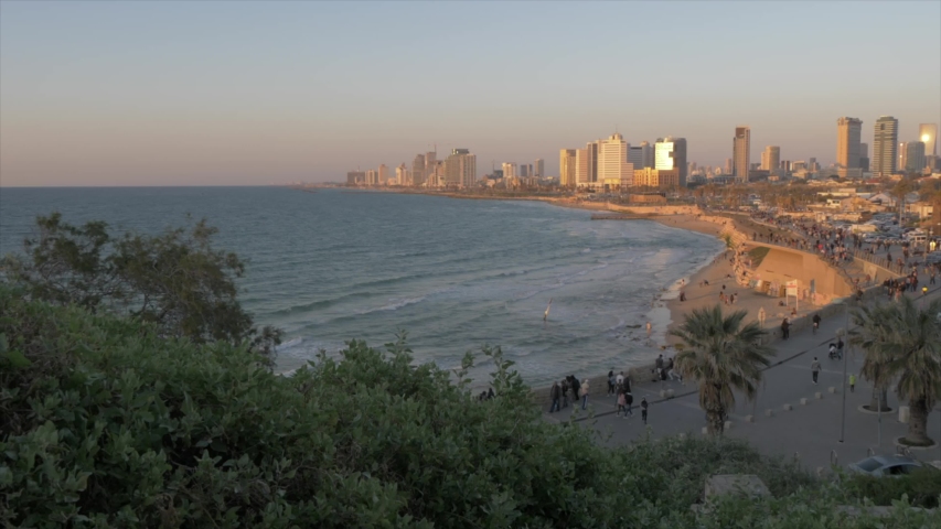 Pan shot of sea and Tel Aviv skyline at sunset from Old Jaffa Town, Tel Aviv, Israel, Middle East
