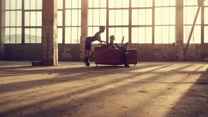 Woman in latex and man in the armchair