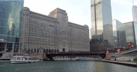 Chicago, Illinois, United States - July 01, 2019: Chicago Architecture Tour Boat passing through the Merchandise Mart Plaza