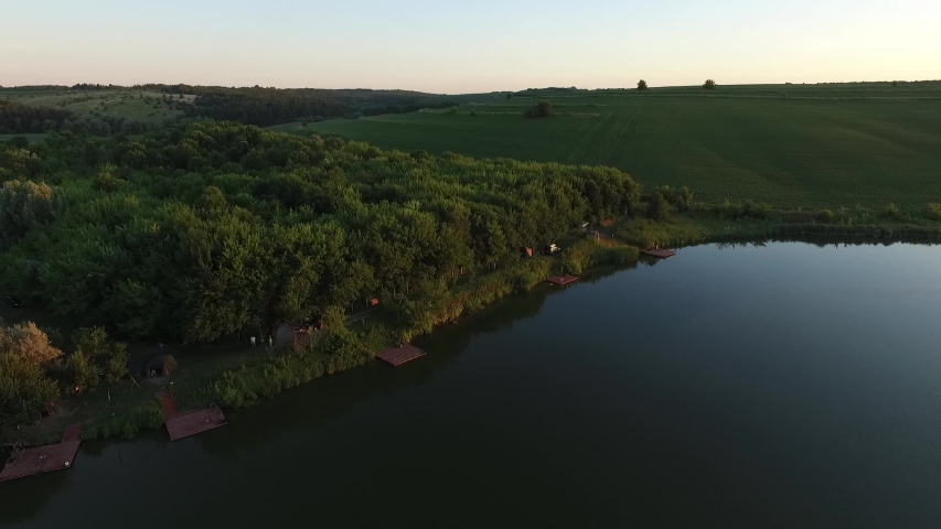 Beautiful landscape from a height. Flying over the river, fields and forests.