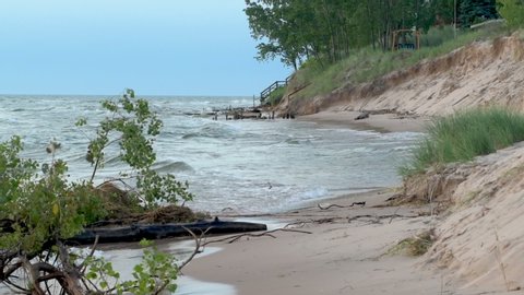 Clip showing waves and significant beach erosion on Lake Michigan. High water levels and wave action have reduced beach size across the Great Lakes. Recorded at Little Sable Point in Michigan in slow 