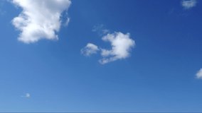 Blue sky with white clouds running by. Skyscape timelaps.
