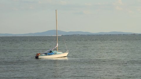Sailing Yacht at Black Sea. A Small Island on the Horizon.
