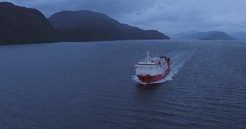 Aerial view of cargo and passenger ferry sailing through the beautiful canals and fjords of southern Patagonia in Chile