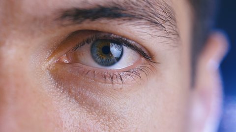 Close up of a male eye. Detail of a eye of a man looking at camera. Macro shot.