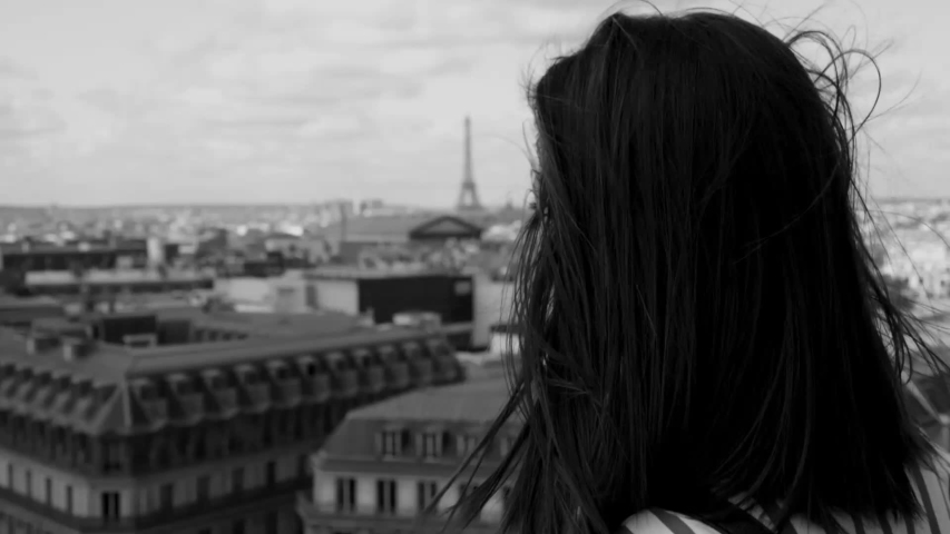French girl in Paris with a view over the rooftops