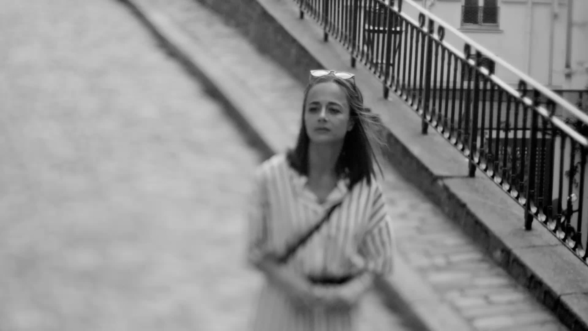 Beautiful girl walks through the streets on a summer day in Paris