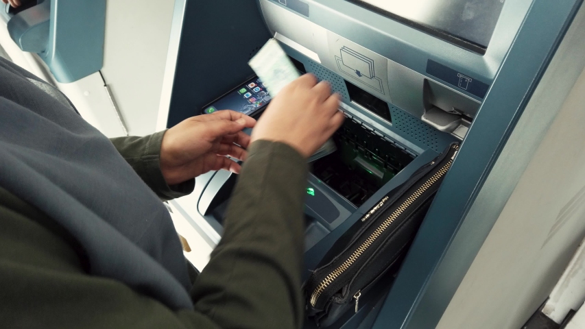 Kedah,malaysia-circa august,2019 : woman inserting money at atm machine for  paying bills.