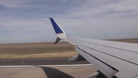 United Airlines plane taking off from Denver Colorado airport from the perspective of a passenger