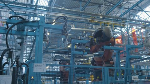 Car production industry. Automotive plant. Robots at the assembly line