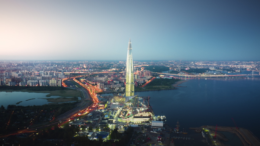 SAINT-PETERSBURG, RUSSIA - JUNE 2019: Beautiful motion timelapse of Lakhta Center in Saint Petersburg on the evening, view from above. Picturesque aerial panorama of the tower with bright lights