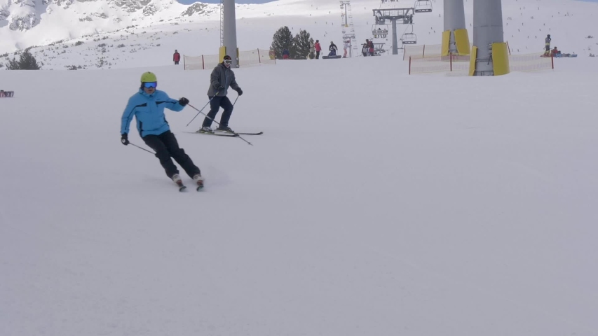 Man Skiing down snowy mountain.