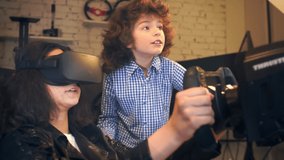 boy helps sister play in virtual car racing on simulator