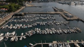 white yachts at the berths in the seaport, aerial view from drone