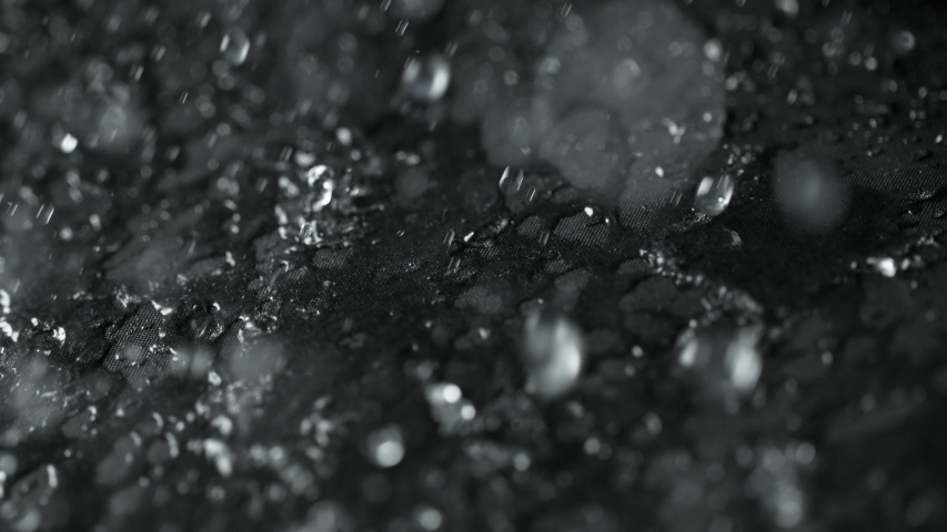 Super Slow Motion Shot of Water Droplets Splashing on Waterproof Cloth at 1000fps. Royalty-Free Stock Footage #1034690999