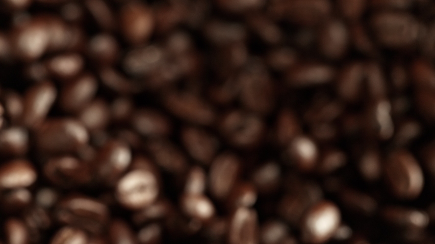 Super Slow Motion Shot of Exploding Premium Coffee Beans Towards the Camera at 1000fps. Royalty-Free Stock Footage #1034691038