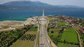 Aerial drone video of world famous cable suspension bridge of Rio - Antirio Harilaos Trikoupis, crossing Corinthian Gulf, mainland Greece to Peloponnese, Patras