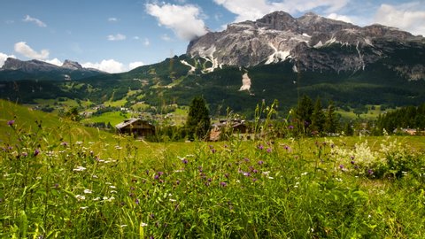 Beautiful panoramic view of the Cortina d'Ampezzo valley with the Tofane Group on background. Sexten Dolomites, Belluno. Italy. Timelapse, Tilt effect. 4K UHD Video.