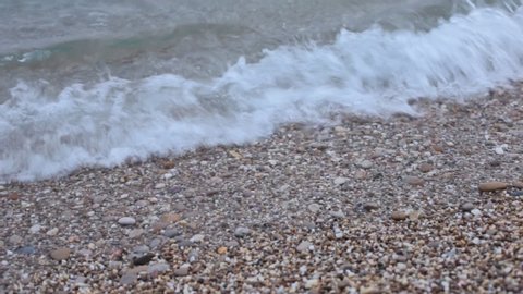 Small waves on the sea coast, pebble beach tide