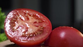 Macro video of the red juicy tomato cutted in a half, raw vegetables at the kitchen, close up food, isolated tomatoes on the table, cooking the salad, Full HD Prores 422 HQ