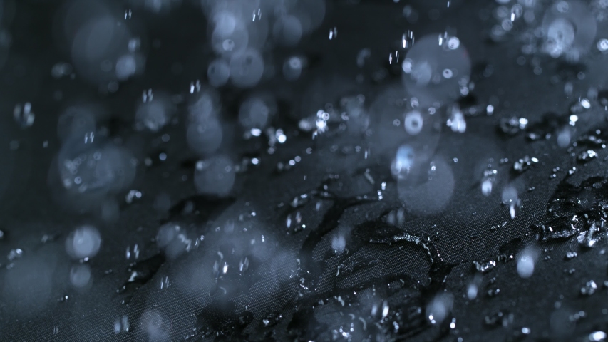 Super slow motion of falling water drops on waterproof cloth texture in detail. Filmed on high speed cinema camera, 1000 fps. Royalty-Free Stock Footage #1034709713