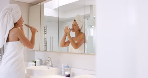 beautiful woman singing in bathroom wearing white towel dancing in front of mirror RED EPIC DRAGON Video Stok