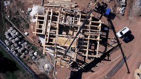 A new home under construction. Clip. Top view of the construction of a wooden house