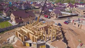 Top view of the process of building a wooden house. Clip. Small unfinished building with wooden ceiling beam on support pipes
