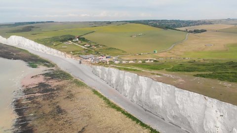 Aerial footage of the famous Seven Sisters chalk cliffs tops by the English Channel. They form part of the South Downs in East Sussex, between the towns of Seaford and Eastbourne in southern England, 