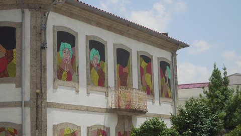 Famalicão / Portugal - 07 23 2019: Famalicão, Portugal, July 23, 2019: "O Manto", colorful street art graffiti made by Ricardo Miranda and Joana Brito in "A casa ao Lado", Famalicão, Portugal.
