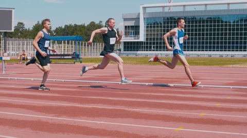 Young professional runners training on outdoor stadium at summer Stock Video