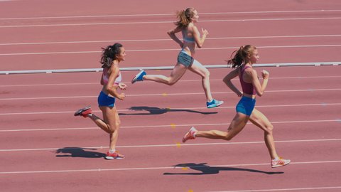 High-angle shot of female sprinter race on outdoor track arena