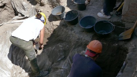 Pompeii, Italy, July 2019: Archaeologists excavating the remaining ruins of Pompeii Italy archeological site for new findings