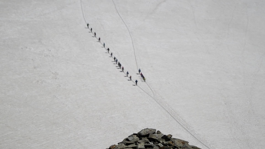 Hikers in a row on the Mont Blanc glacier