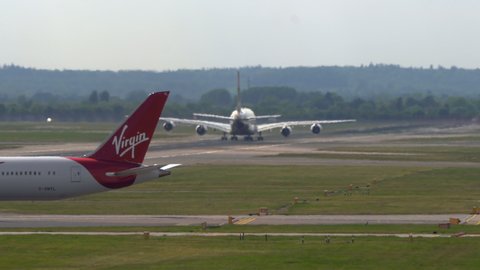 London Heathrow, United Kingdom - 05 12 2019: 4k Super-telephoto 747 plane takes off with heat shimmer