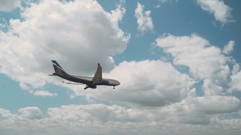 London Heathrow, United Kingdom - 05 12 2019: Slow-motion Aeroflot plane flies past blue sky and clouds