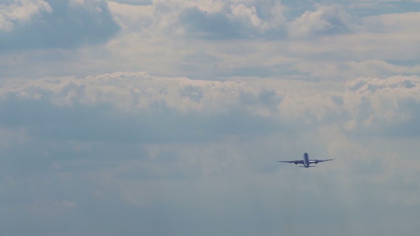 4k Incredibly smooth super-telephoto view of plane passing clouds 4 Royalty-Free Stock Footage #1034742020