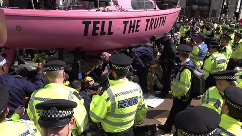 London / United Kingdom (UK) - 04 19 2019: Police surround climate change protest pink boat roadblock