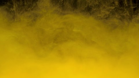 Brilliant golden ink mixing in water, swirling softly underwater with copy space. Colored acrylic cloud of paint isolated. Abstract smoke explosion animation. Universe. Art background. Slow motion. 4K