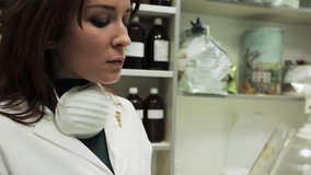 Good look Pharmacist woman  checking the consistency of some liquid in a glass flask. Perfect clip for videos about medicine, chemistry and science. Video made in the chemical laboratory