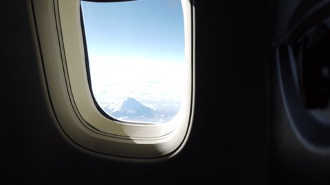 Beautiful view from aeroplane window seat with nice blue sky and Mt. Fuji. handheld shots