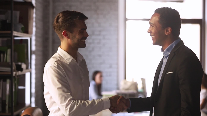 European and black businessmen stands in co-working office discuss document contract details finish talk shaking hands, client and executive manager effective meeting, synergy working together concept Royalty-Free Stock Footage #1034756150
