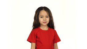 Portrait a little female in red T-shirt up her hand on white background. Happy little girl smiling up her hand on white screen and have fun. 4k